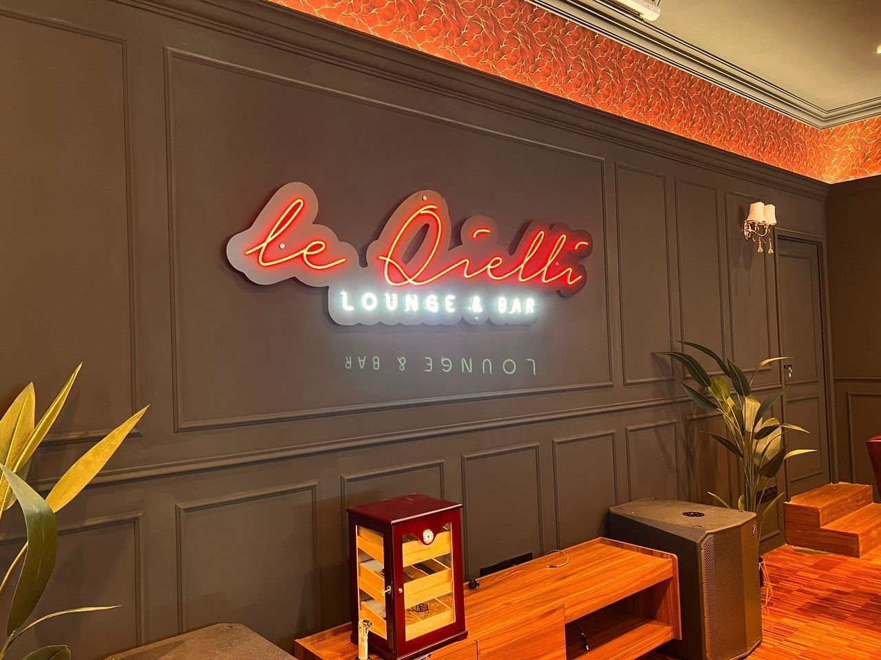 Entrance with a vibrant neon sign of Le Qielli Lounge & Bar at Hotel Maya Kuala Lumpur City Centre