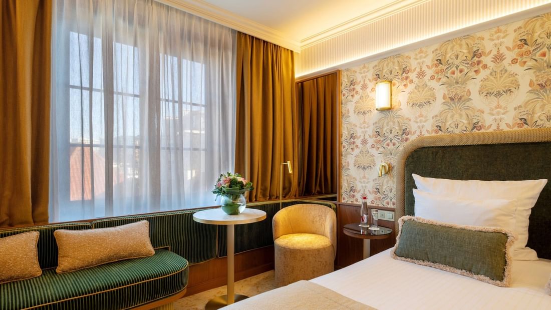 Superior Room with floral wallpaper, plush seating, and city views at Warwick Brussels Grand-Place