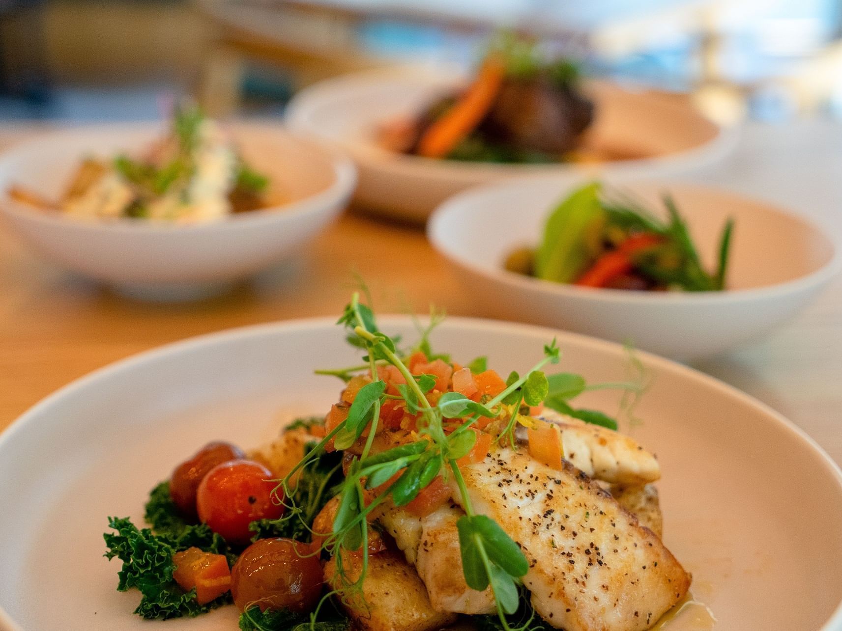 Salmon dish served on a table in Nook Restaurant & Bar at Nesuto Stadium Hotel and Apartments