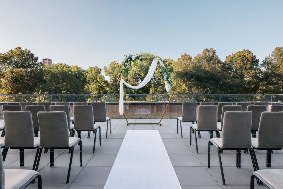 Winter Garden terrace with chairs and floral arch overlooking trees in The Study at the University of Chicago