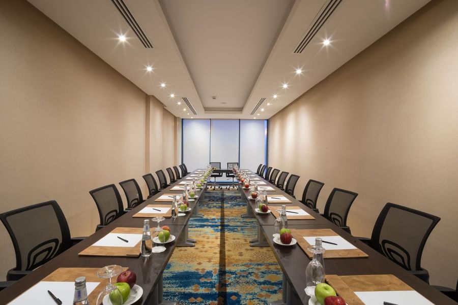 U-shape conference setup with mesh chairs in Khaleej Meeting Room at Naviti by Warwick Dammam