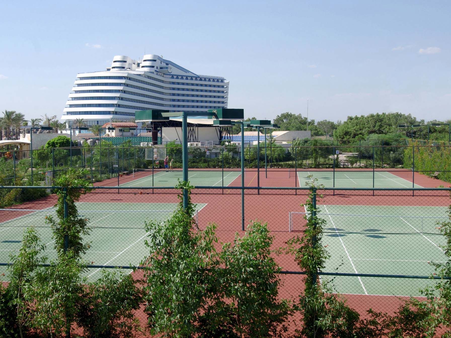 Exterior view of the hotel and the tennis court in Lara Tennis court at Titanic Deluxe Lara