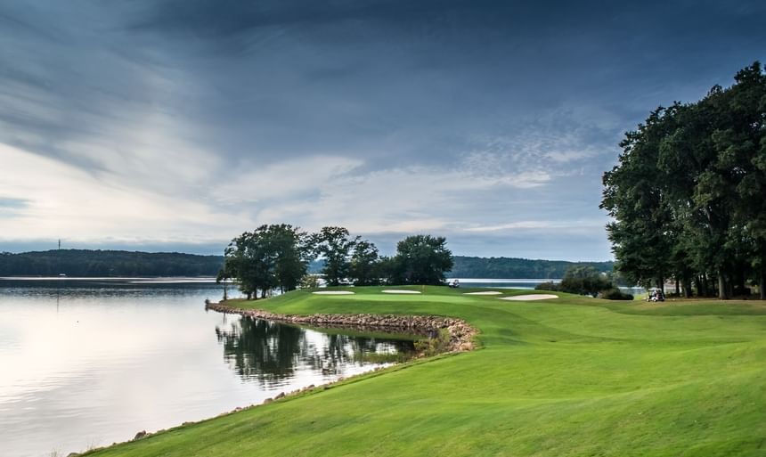 Lakeside golf course green with white sand bunkers by Lake Hartwell waters at Clemson University Conference Center & Inn