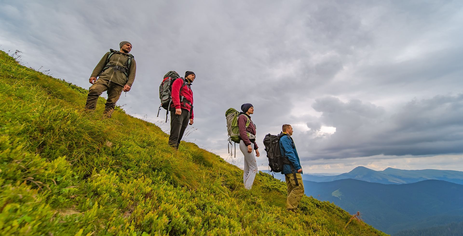 Group of hikers enjoying the view on a steep mountaintop near Eldorado, a Coast Hotel