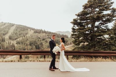 A bride & groom posing outdoors at Stein Eriksen Lodge