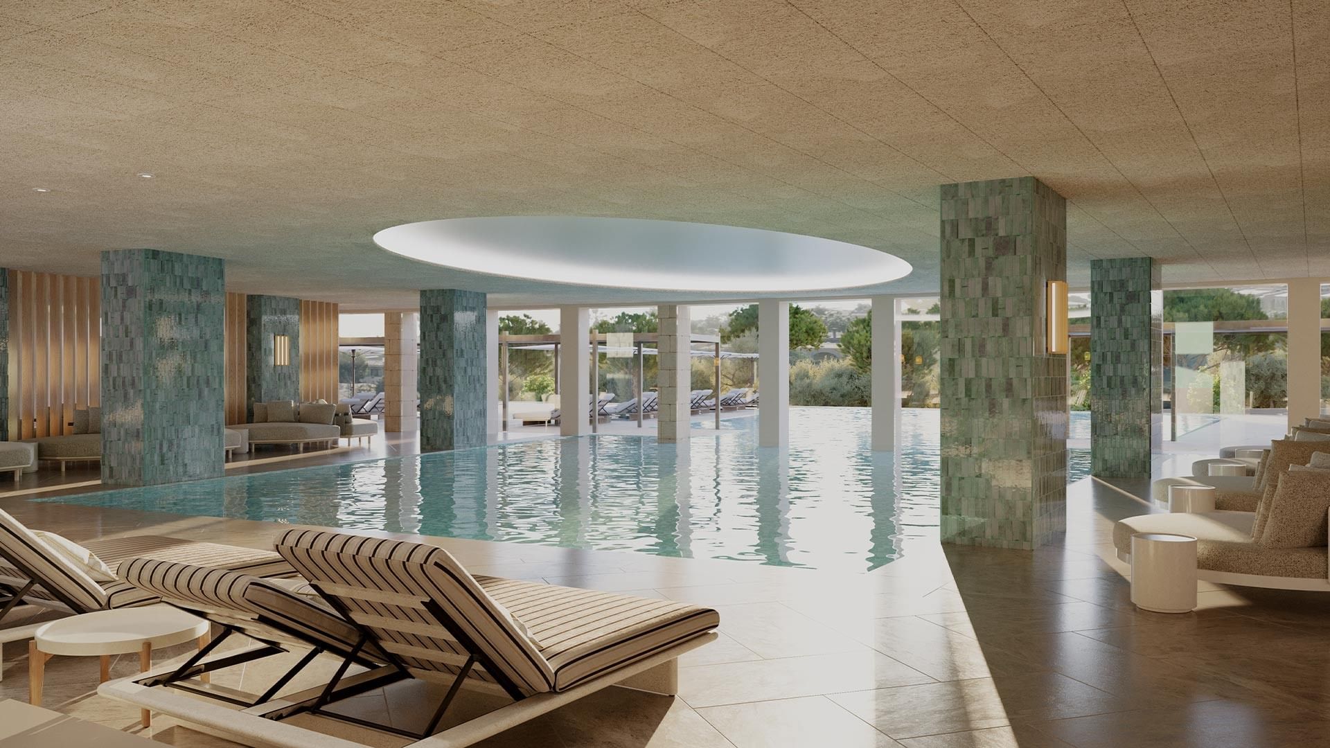 Indoor pool area with lounge chairs, a circular skylight, and large columns with mosaic tiles.