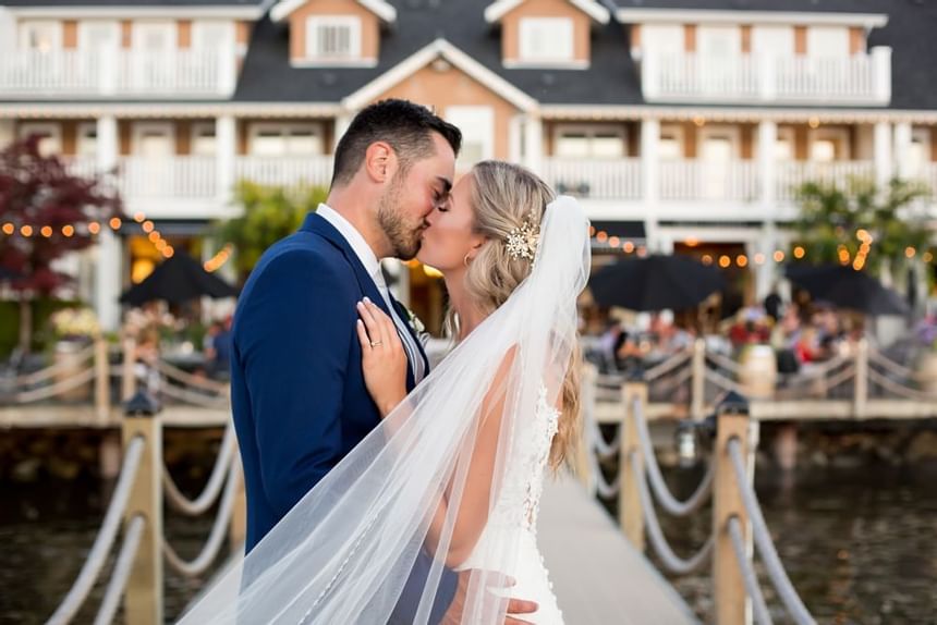 Close-up of bride and groom kissing on a dock at Hotel Eldorado