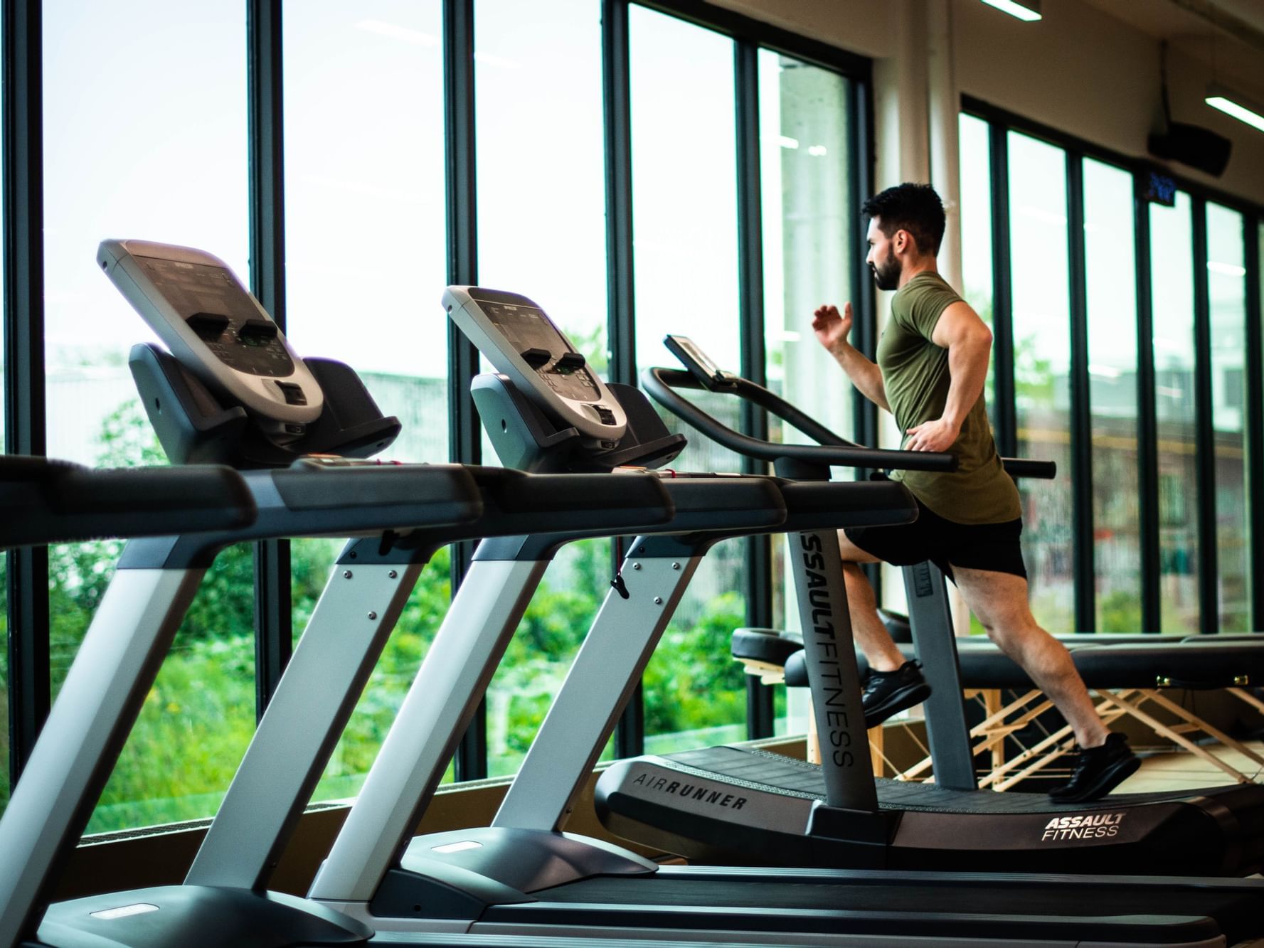 A man running on a treadmill with a view at Blue Doors Hotels