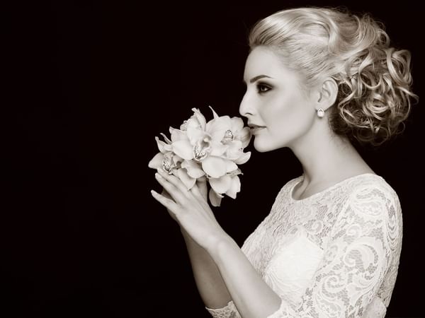 B & W portrait of a bride holding a flower at Warwick Melrose