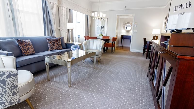 Dining area and lounge area in The Avenue One Bedroom Suite at Warwick New York
