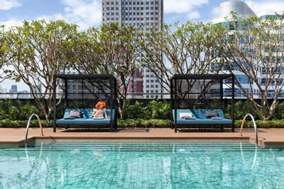 Lady on pool bed at Carlton Hotel Bangkok Sukhumvit