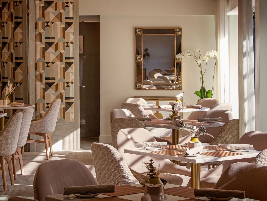 Cozy chairs and table set for dining at Luxe Sunset Boulevard