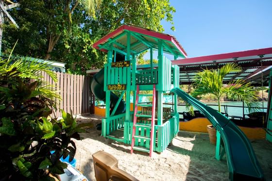 An outdoor kids playground at True Blue Bay Resort