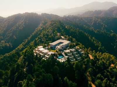Aerial view of The Terraces Resort & Spa among lush green hills