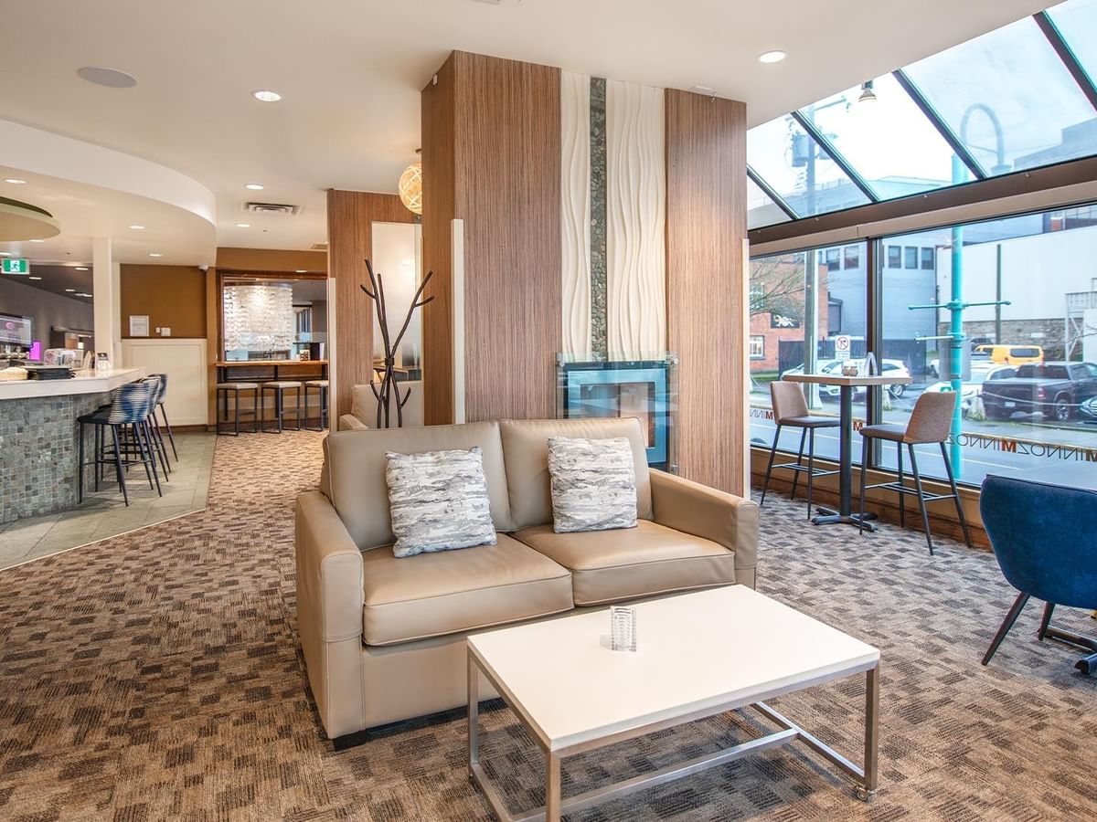Minnoz Restaurant + Lounge with modern seating and glass windows at Coast Bastion Hotel in Nanaimo.