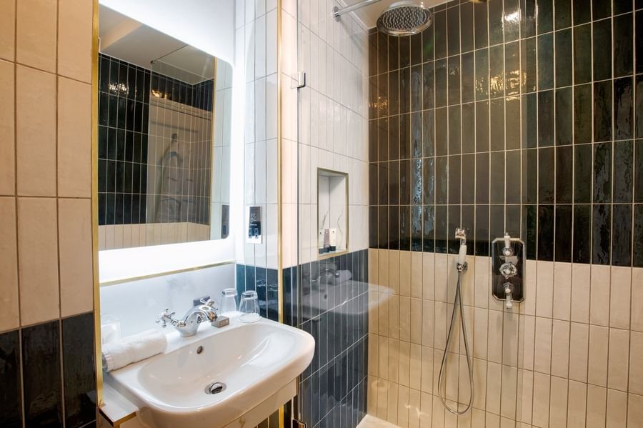 Superior King bathroom featuring a marble vanity with glass shower at The Capital Hotel, Apartments and Townhouse
