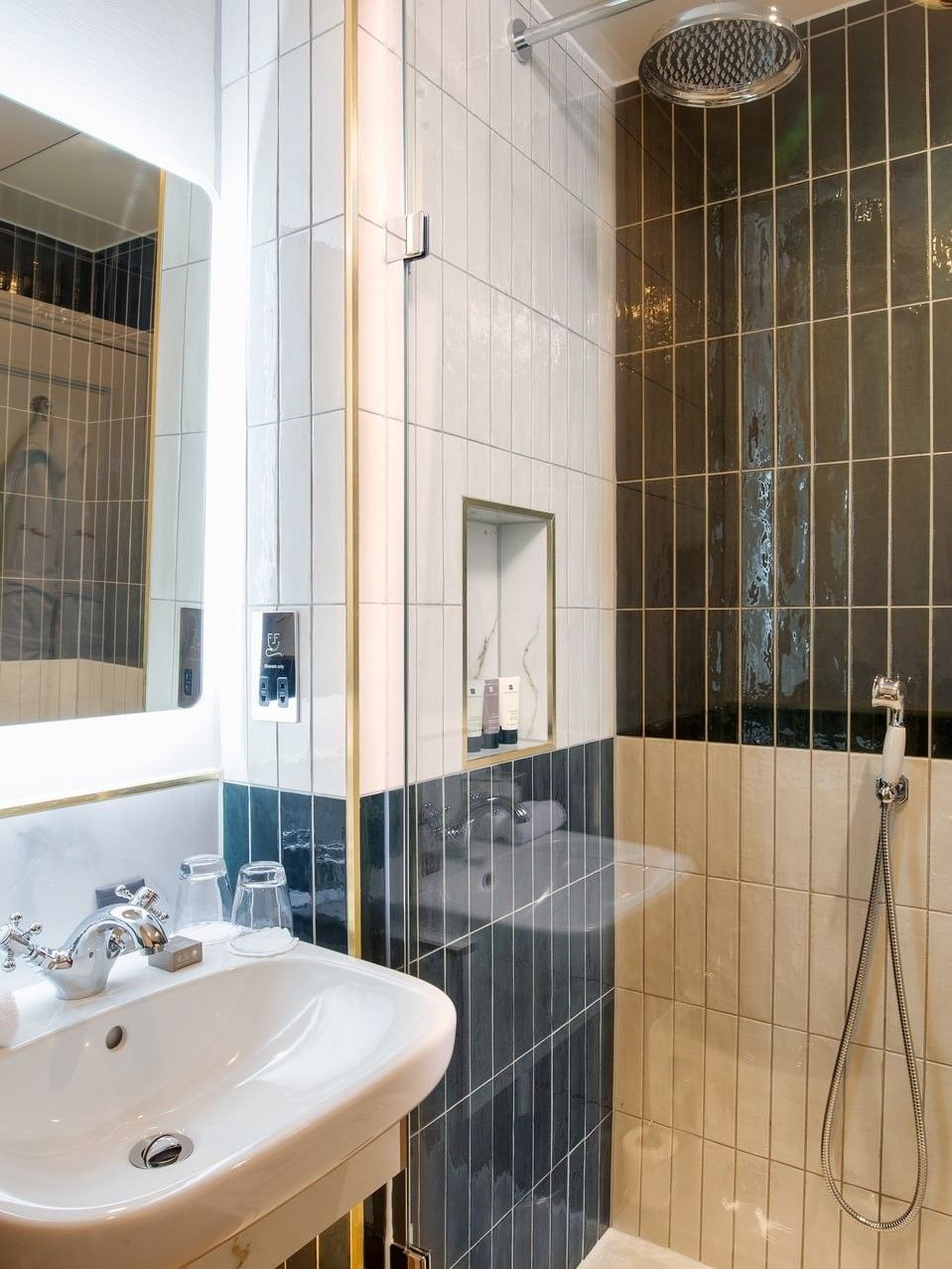 Modern bathroom with tiled walls and shower area in an executive room at The Capital Hotel