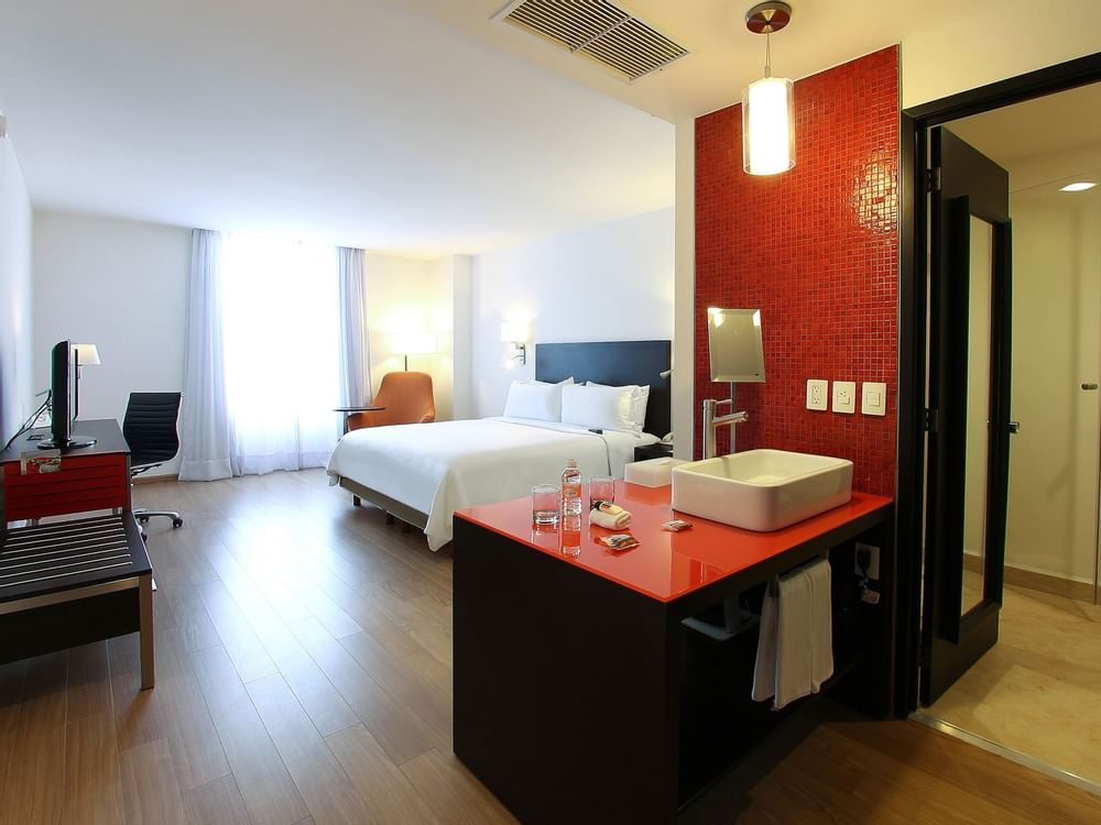 Large bed & vanity area in Deluxe Room 1 King at Fiesta Inn