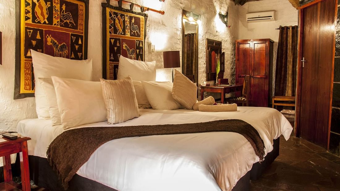 Double comfy beds, dressing table, and provided air conditioning in Deluxe Room at Kedar Heritage Lodge, Conference Centre & Spa