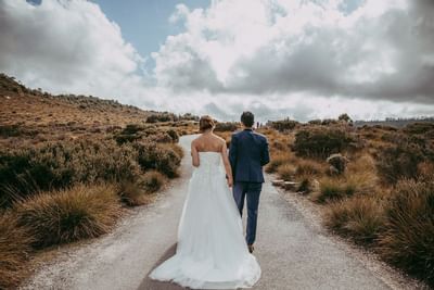 Wedding couple walking on a road near Cradle Mountain Hotel