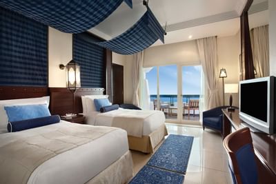 Twin deluxe room with tv screen by sea view at Ajman Hotel