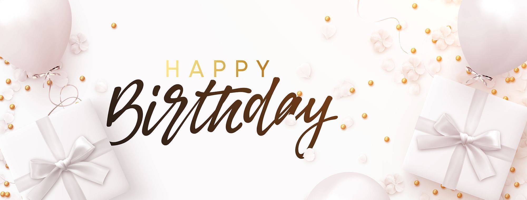 Happy Birthday text by gold beads and white flower petals background used at Warwick Hotels & Resort