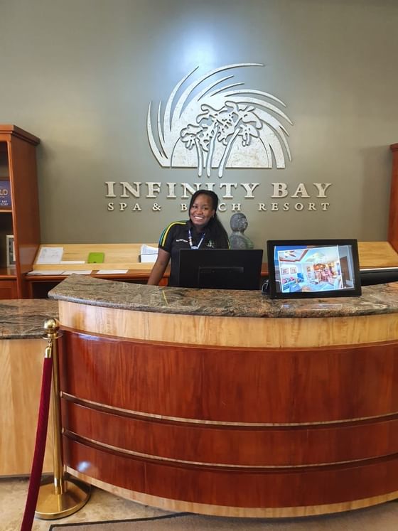 A receptionist at the front desk in Infinity Bay Resort
