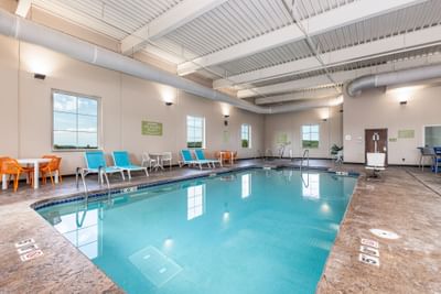 Indoor swimming pool area with sun loungers and tables at Off Shore Resort