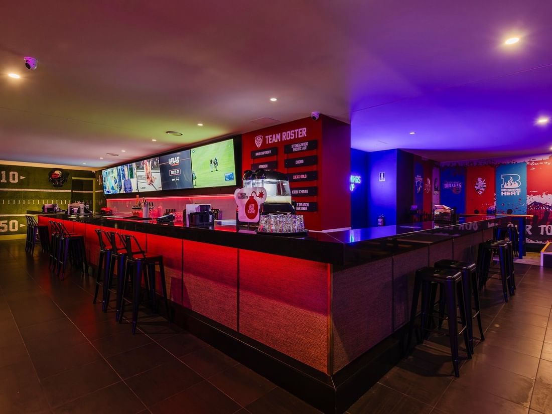 Illuminated main counter with TV and team rosters in KG Sport Bar at Mercure Brisbane King George Square