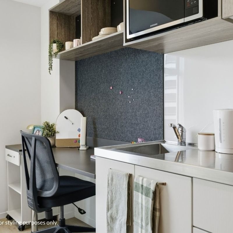 Modern kitchen with desk and chair at Mayoral Drive Student Accommodation.