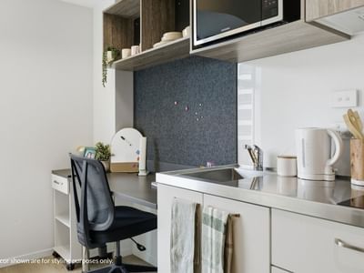Modern kitchen with desk and chair at Mayoral Drive Student Accommodation.