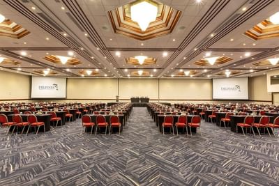 Classroom set-up in the Mediterranean Room with projector screens and carpeted floors at Hotel Los Delfines & Casino