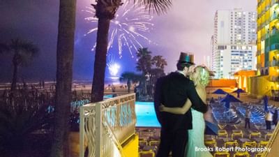 bride and groom kissing during fireworks