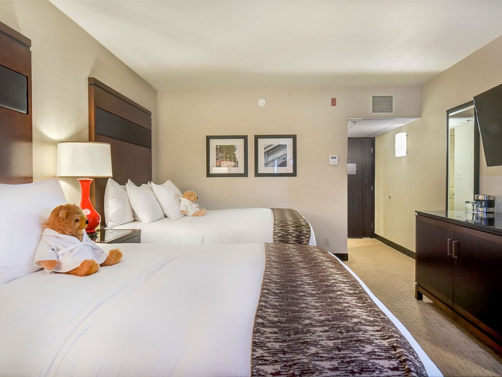 Double bedroom with 2 beds & furniture in a room at Hotel 43