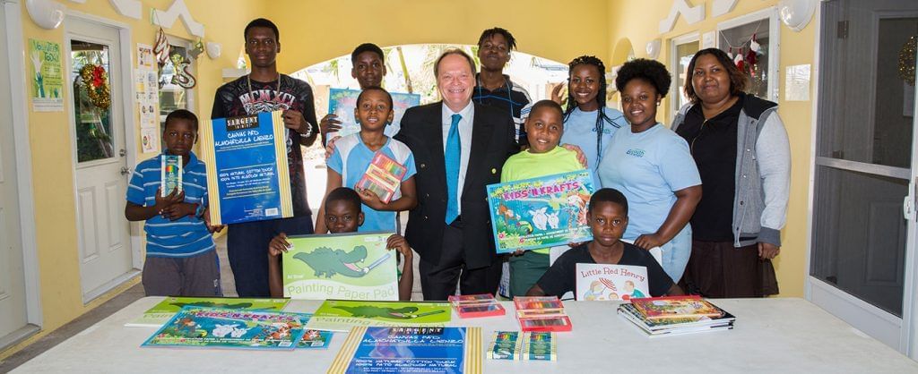 Children holding books, their hands, The Somerset On Grace Bay