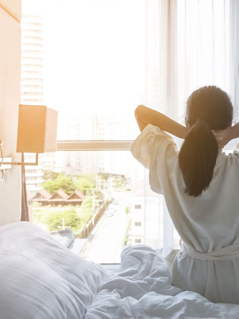 Stay Longer and Save poster with lady stretching on the bed in the background at The Independent