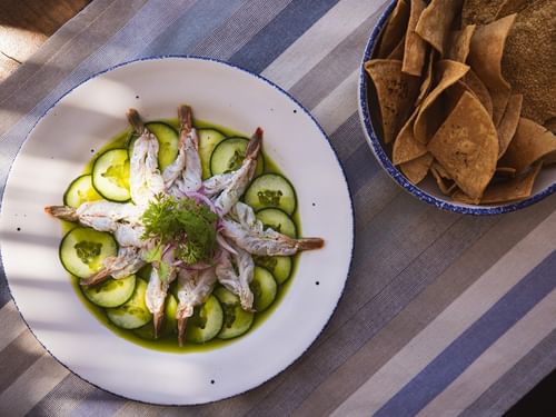 Plate of shrimp and cucumbers with a side of tortilla chips at Tortugas, Hacienda Del Mar Los Cabos in Cabo San Lucas.
