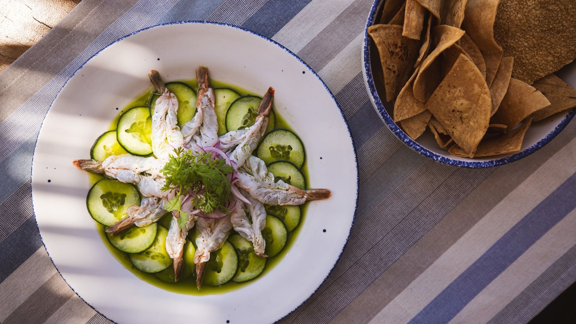 Plate of shrimp and cucumbers with a side of tortilla chips at Tortugas, Hacienda Del Mar Los Cabos in Cabo San Lucas.