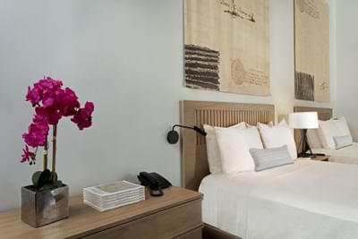 Bed and pink flower in hotel room