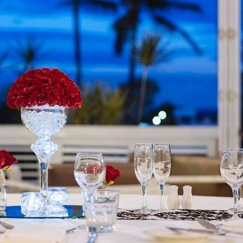 Elegant dining table set with glassware and centerpiece of roses at Mercure Townsville