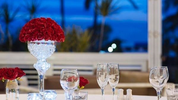 Elegant dining table set with glassware and centerpiece of roses at Mercure Townsville