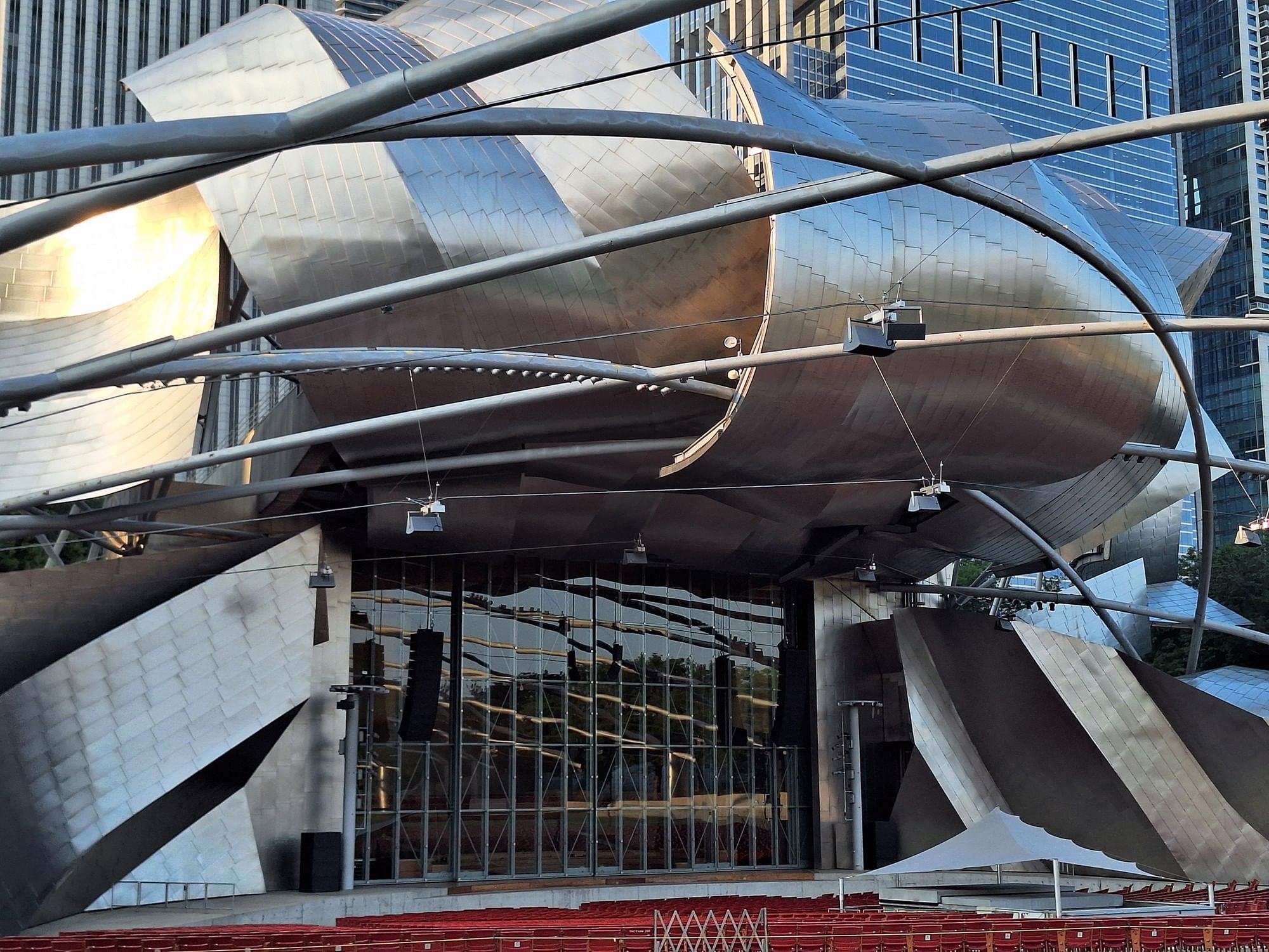 Modern metallic structure with glass facade and red seating at Warwick Allerton Chicago