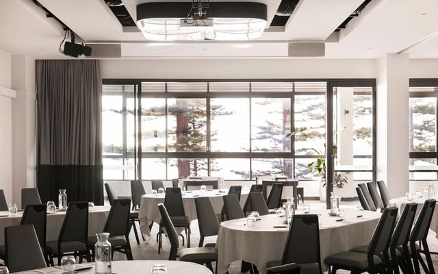 Pacific Ballroom at Elysium Manly with tables under modern ceiling lights & chairs around, an elite hotel in Manly
