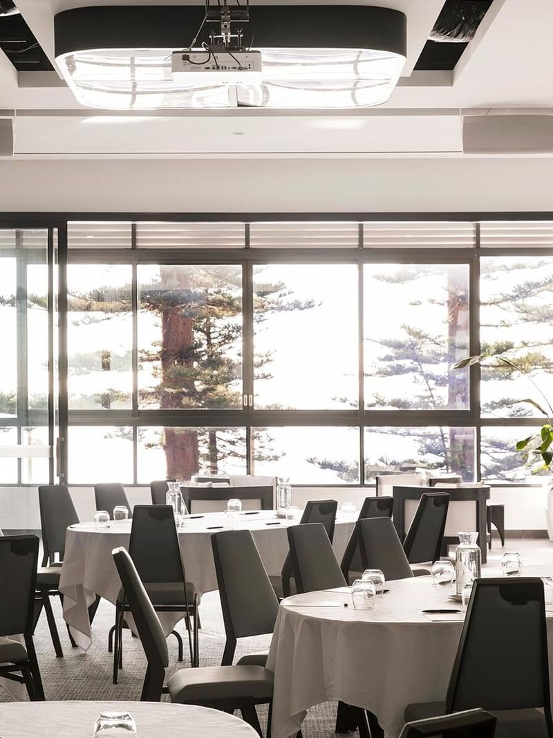 Pacific Ballroom at Elysium Manly with tables and many grey chairs around, a premier Manly event venue