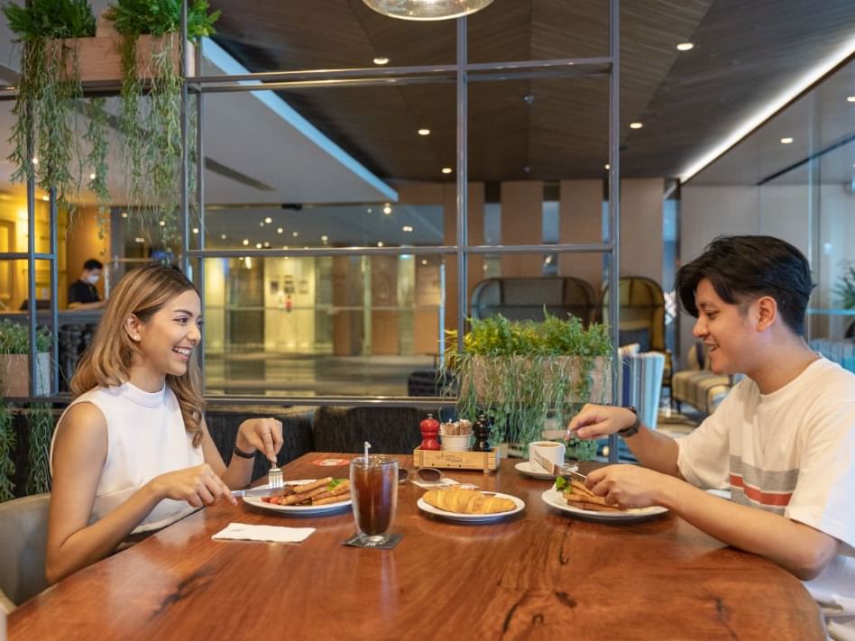 Couple having breakfast at Maitria Hotel Sukhumvit 18