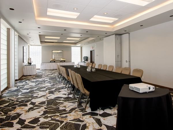 Long table with chairs in a conference room.