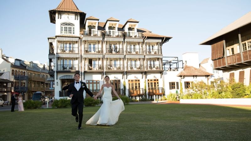 Wedded couple running on the field