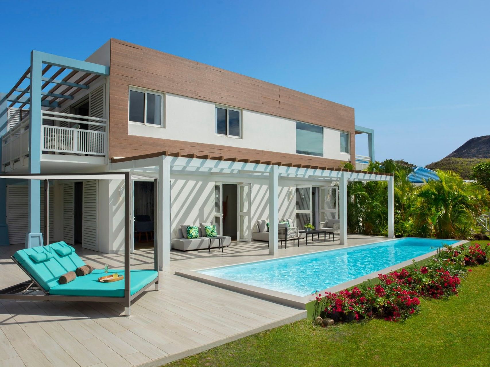 Exterior view of St. Martin Presidential 1 Bedroom Suite with pool area and sun loungers at Saint Martin Beach Resort & Spa