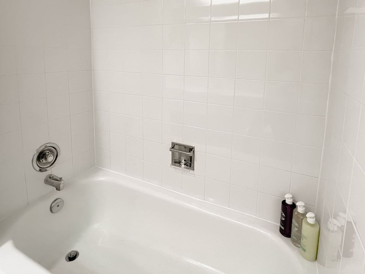 Bath with bottles of shampoos, body washes