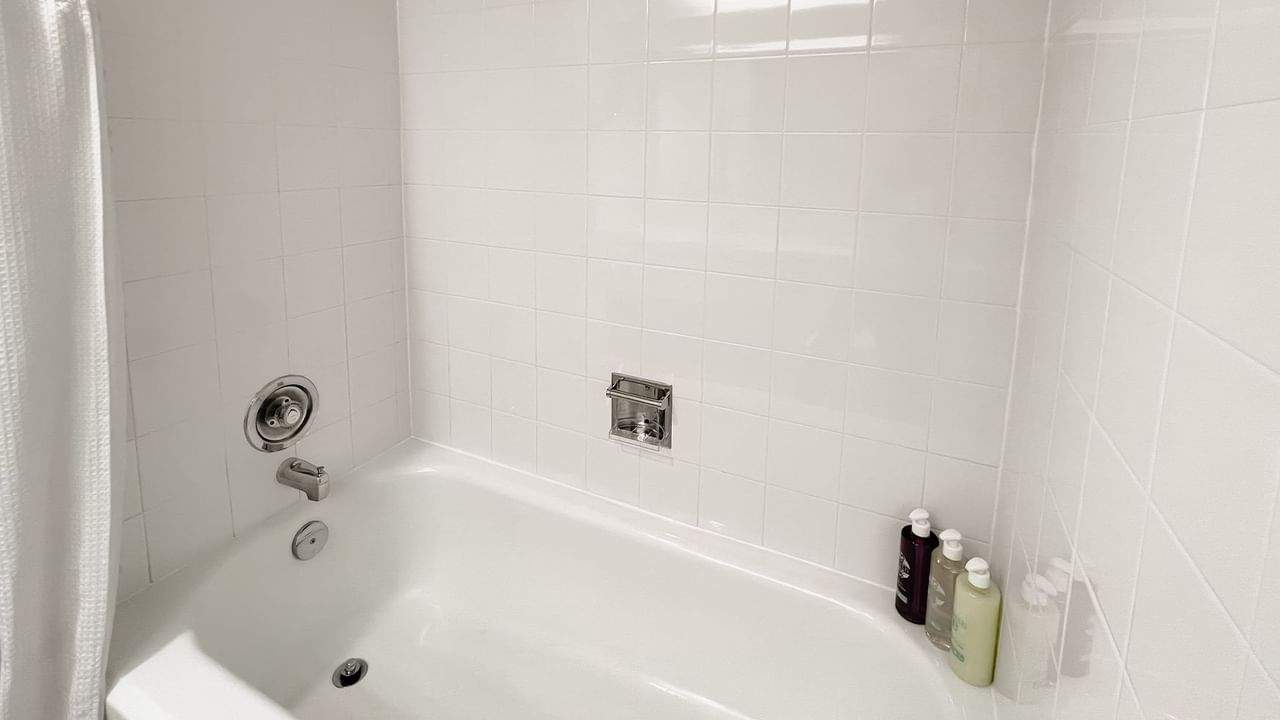 Bath with bottles of shampoos, body washes